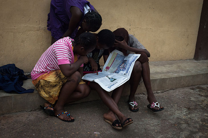 Children orphaned by the conflict in northern Nigeria read a newspaper about abducted girls in the north. © 2014 Watchlist/Ruth McDowall.