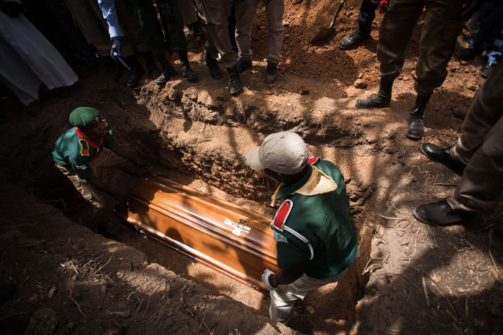 In this photo people carry the casket of a scout on security at his church in Jos, Nigeria, where a suicide bomber in a car detonated a bomb outside the church.  Jama’atu Ahlis Sunna Lidda’awati wal-Jihad, commonly known as Boko Haram, claimed responsibility for the attack. © 2012 Ruth McDowall.